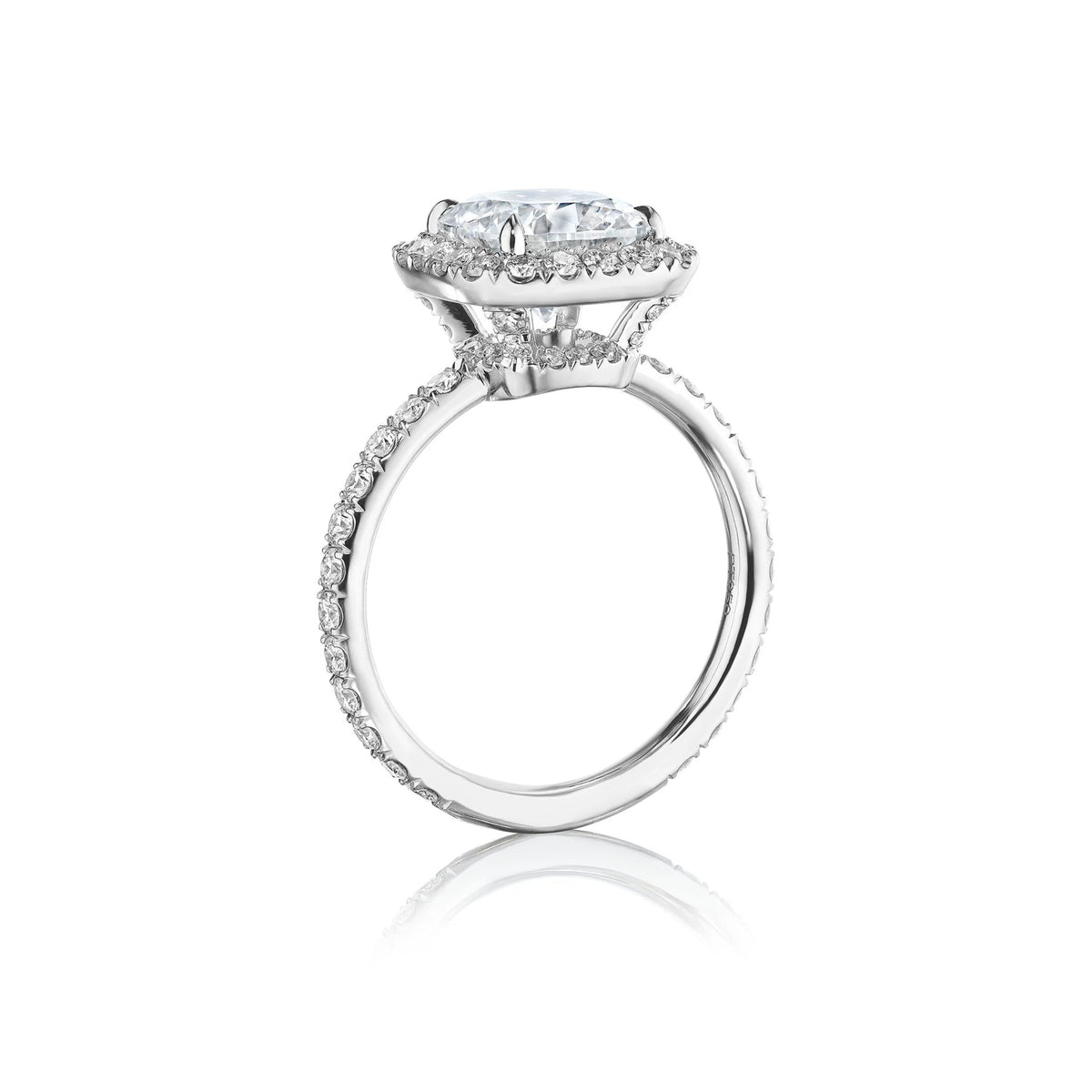 Custom cushion cut diamond engagement ring with pavé halo in 18k gold, side view