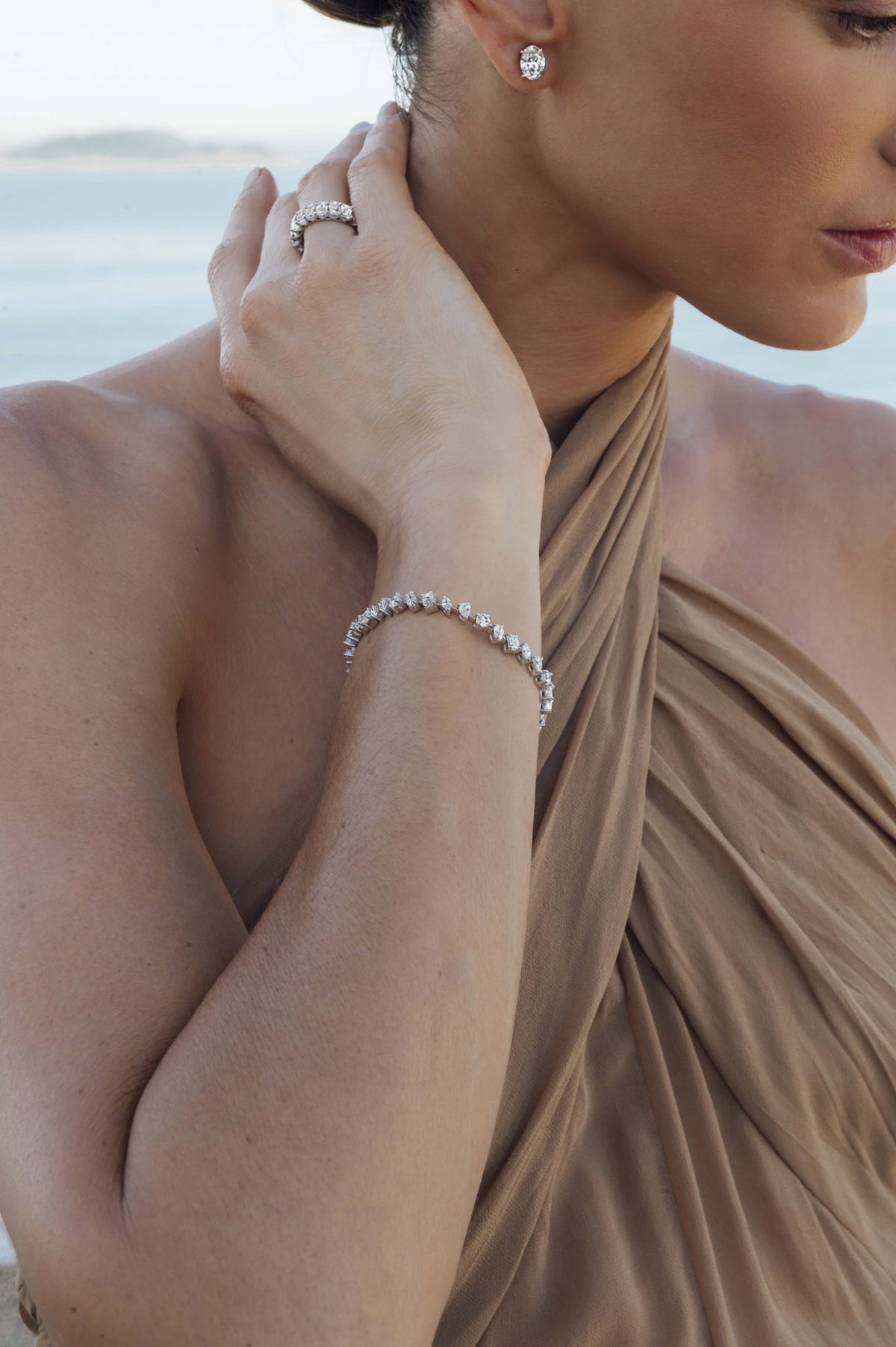 Multi-shape diamond tennis bracelet in 18k white gold, worn on the wrist