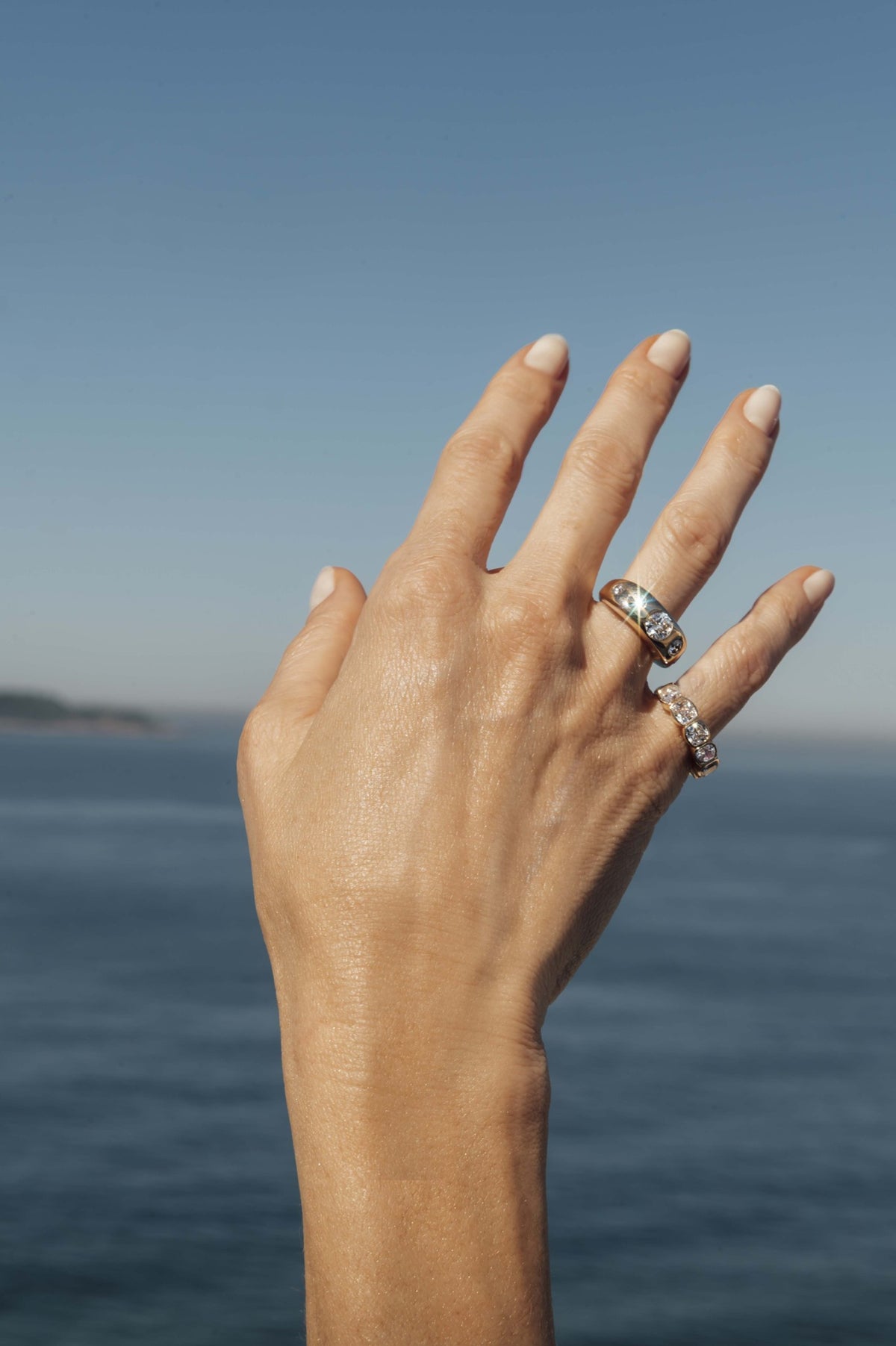 Five diamond bombé cocktail ring in 18k yellow gold, worn on the hand