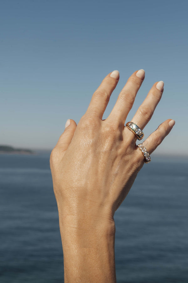 Five diamond bombé cocktail ring in 18k yellow gold, worn on the hand