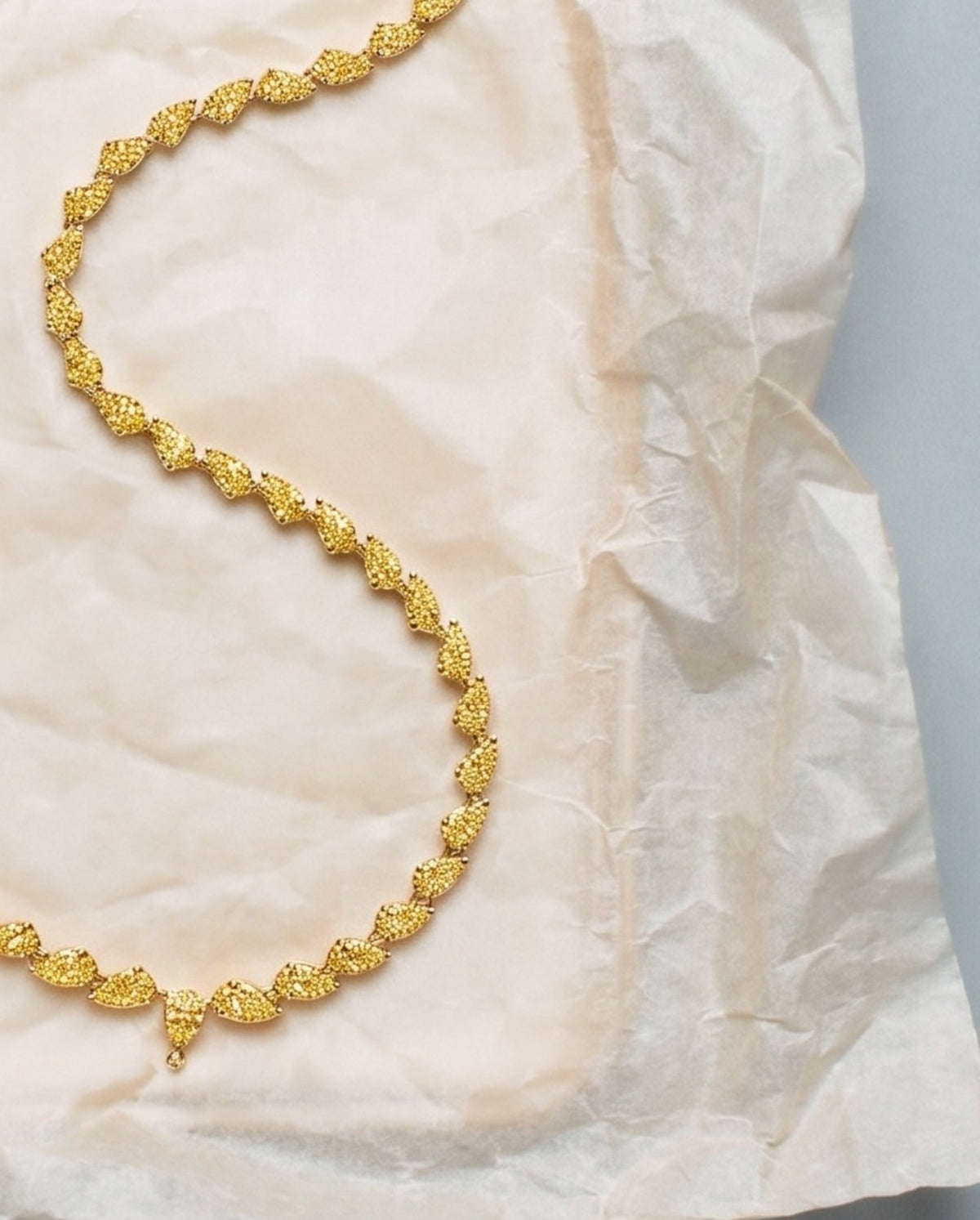 Fancy yellow diamond rivière necklace in 18k yellow gold, styled