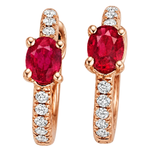 A pair of rose gold huggie hoop earrings featuring a large oval-cut red ruby center stone and a channel-set row of round diamonds along the band, shown on a clean white background.
