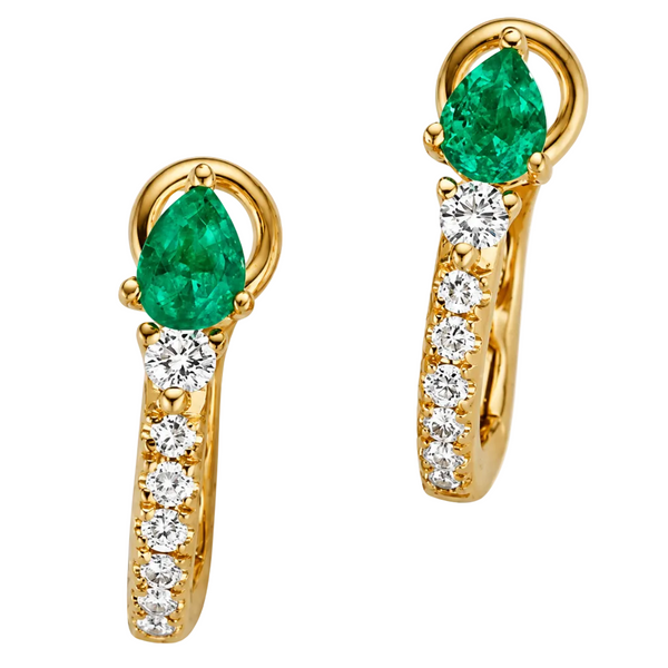 A pair of gold huggie hoop earrings featuring a large pear-cut green emerald and a channel-set row of clear round diamonds, shown on a clean white background.